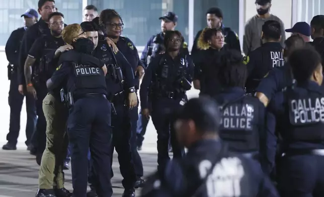 Dallas Police Department officers comfort each other following a guard of honor outside of Dallas County Medical Examiner office, on Friday, Aug. 30, 2024, in Dallas. (Shafkat Anowar/The Dallas Morning News via AP)