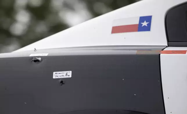 Dallas Police Department squad car 2149 is towed away near the scene of a shooting in Dallas on Friday, Aug. 30, 2024. (Juan Figueroa/The Dallas Morning News via AP)