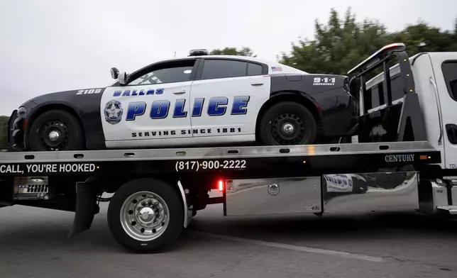 Dallas Police Department squad car is towed away near the scene of a shooting in Dallas on Friday, Aug. 30, 2024. (Juan Figueroa/The Dallas Morning News via AP)