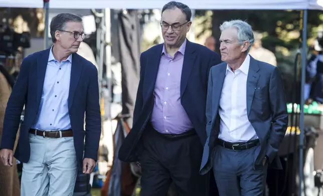 Governor of the Bank of Canada Tiff Macklem, left, and Governor of the Bank of England Andrew Bailey, center, walk with Federal Reserve Chairman Jerome Powell at the Jackson Hole Economic Symposium at Jackson Lake Lodge in Grand Teton National Park near Moran, WY on Friday, Aug. 23, 2024. (AP Photo/Amber Baesler)