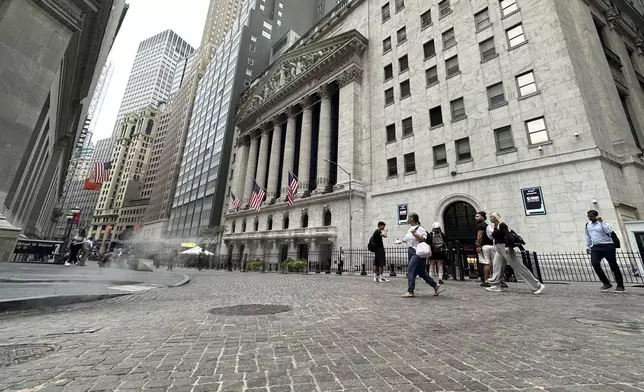 FILE - People pass the New York Stock Exchange on July 31, 2024 in New York. World shares have tumbled on Friday, August 2, 2024, with Japan's Nikkei 225 index slumping 5.8% as investors panicked over signs of weakness in the U.S. economy.(AP Photo/Peter Morgan, File)