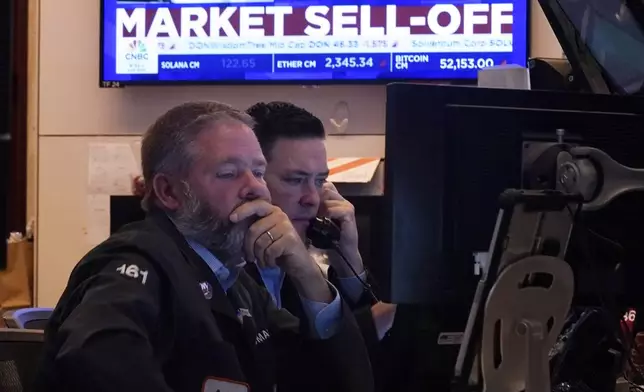 A pair of traders work on the floor of the New York Stock Exchange, Monday, Aug. 5, 2024. Nearly everything on Wall Street is tumbling as fear about a slowing U.S. economy worsens and sets off another sell-off for financial markets around the world. (AP Photo/Richard Drew)