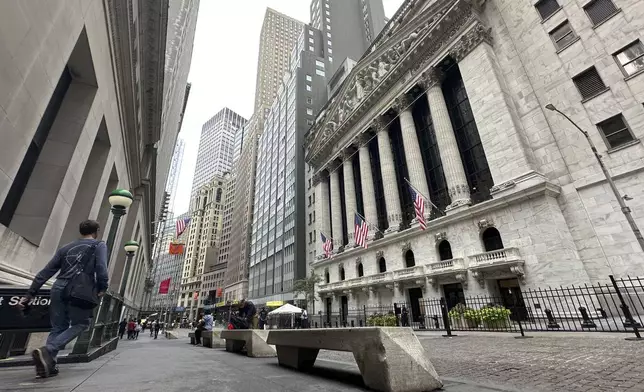 FILE - People pass the New York Stock Exchange on July 30, 2024 in New York. Japan's benchmark Nikkei 225 stock index has lost 12.4% on Monday, August 5, 2024, in the latest bout of sell-offs that are jolting world markets. (AP Photo/Peter Morgan, File)