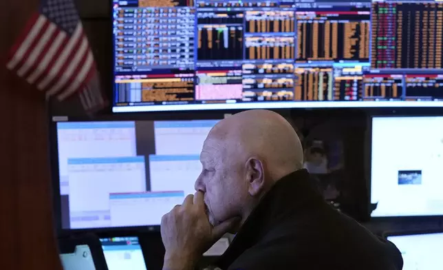 Trader Robert Moran works in his booth on the floor of the New York Stock Exchange, Wednesday, Aug. 7, 2024. (AP Photo/Richard Drew)