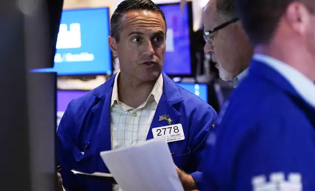 Specialist Michael Gagliano, left, confers with a colleague on the floor of the New York Stock Exchange, Monday, Aug. 5, 2024.(AP Photo/Richard Drew)