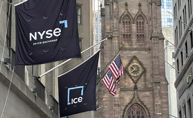 Flags fly on the side of the New York Stock Exchange with Trinity Church in the background on Wednesday, Aug. 28, 2024, in New York. (AP Photo/Peter Morgan)