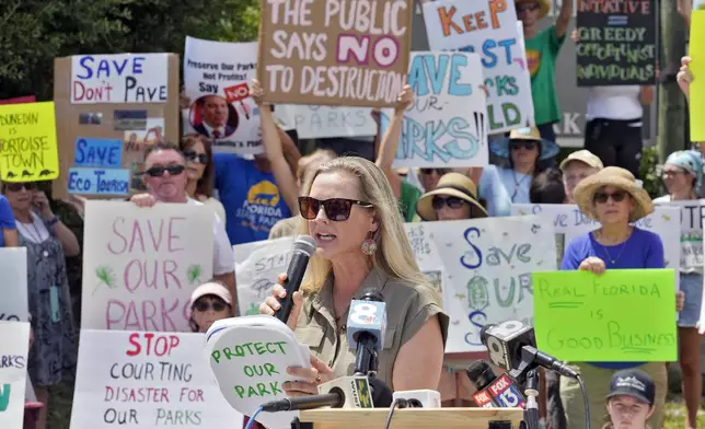 Democratic Florida State Rep. Lindsay Cross speaks to supporters against development at Florida state parks outside the entrance to Honeymoon Island State Park Tuesday, Aug. 27, 2024, in Dunedin, Fla. (AP Photo/Chris O'Meara)