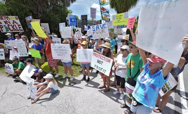 Protestors against development at Florida's state parks gather for a rally at the entrance to Honeymoon Island State Park Tuesday, Aug. 27, 2024, in Dunedin, Fla. (AP Photo/Chris O'Meara)