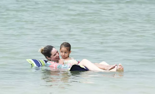 Bathers enjoy the warm water at Oleta River State Park, Thursday, Aug. 22, 2024, in North Miami Beach, Fla. (AP Photo/Marta Lavandier)