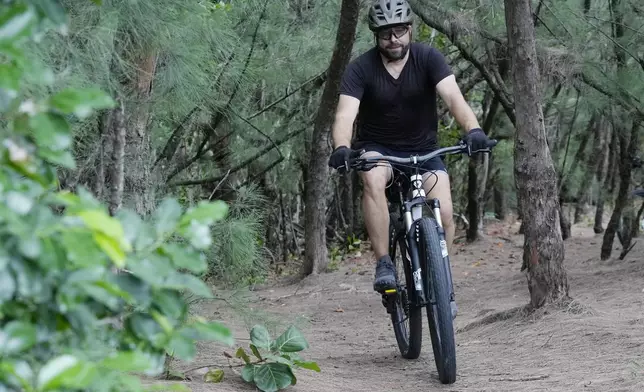 Javier Fernandez, of Hollywood, rides on a mountain bike trail at Oleta River State Park, Thursday, Aug. 22, 2024, in North Miami Beach, Fla. (AP Photo/Marta Lavandier)