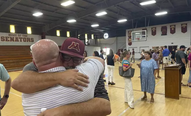 Jamie Tellier, father of Caden Tellier, hugs a student after a memorial service for Tellier's son in Selma, Ala., Monday, Aug. 26, 2024. (AP Photo/Safiyah Riddle)