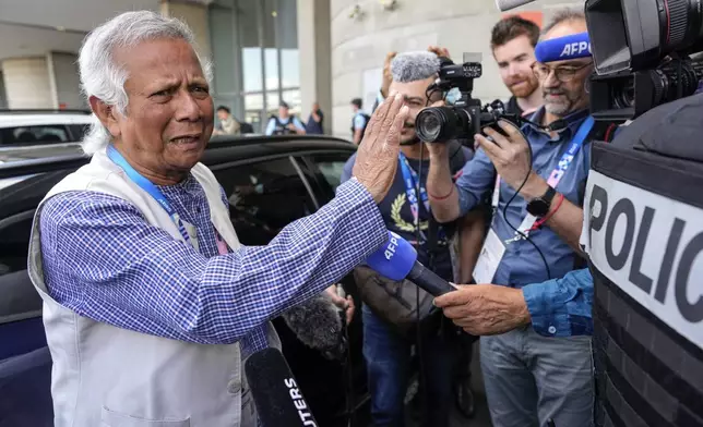 Nobel laureate Muhammad Yunus gestures while speaking to the media upon arriving at Charles de Gaulle's airport in Roissy, north of Paris, Wednesday, Aug. 7, 2024. (AP Photo/Michel Euler)