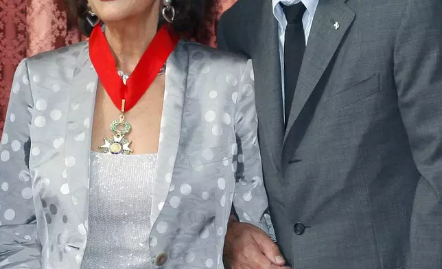 FILE - Italian actress Claudia Cardinale, left, stands next to French actor Alain Delon after she was awarded the "Legion of Honor" at the Elysee Palace in Paris on July 3, 2008. Alain Delon, the internationally acclaimed French actor who embodied both the bad guy and the policeman and made hearts throb around the world, has died at age 88, French media reported. (AP Photo/Benoit Tessier, Pool, File)