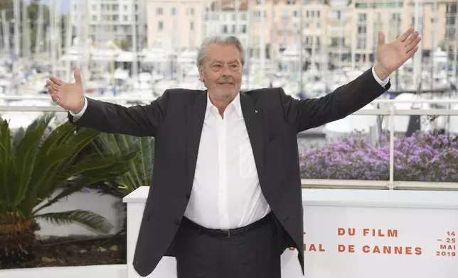 FILE- In this May 19, 2019 file photo, French actor Alain Delon poses for photographers at the photo call for his honorary Palme D'Or award at the 72nd international film festival, Cannes, southern France. Alain Delon, the internationally acclaimed French actor who embodied both the bad guy and the policeman and made hearts throb around the world, has died at age 88, French media reported. (Photo by Arthur Mola/Invision/AP, File)