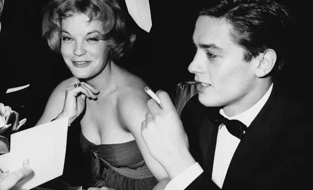 FILE - Romy Schneider and French actor Alain Delon, recently engaged, sit with friends attending the Easter Gala on March 30, 1959 at the Sporting Club of Monaco. (AP Photo, File)