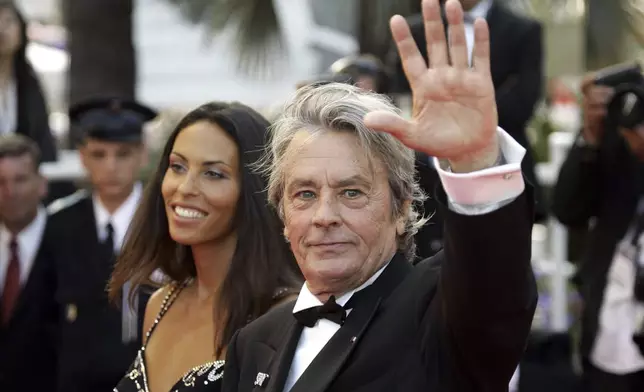 FILE - French actor Alain Delon and model Bianca di Sofia arrive for the screening of the film "Chacun Son Cinema" ("To Each His Own Cinema"), at the 60th International film festival in Cannes, southern France, on Sunday, May 20, 2007. Alain Delon, the internationally acclaimed French actor who embodied both the bad guy and the policeman and made hearts throb around the world, has died at age 88, French media reported. (AP Photo/Andrew Medichini)