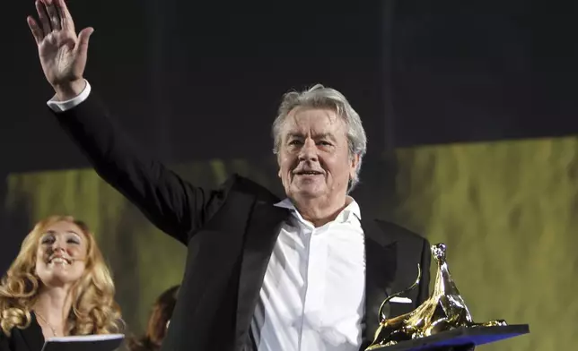 FILE - French actor Alain Delon receives a Lifetime Award during an awarding show at the Locarno Film Festival, on Aug. 2, 2012, in Locarno, Switzerland. Alain Delon, the internationally acclaimed French actor who embodied both the bad guy and the policeman and made hearts throb around the world, has died at age 88, French media reported. (AP Photo/Keystone, Urs Flueeler, File)