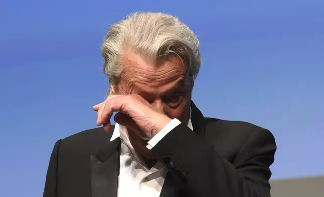 FILE - French actor Alain Delon wipes away a tear prior to being awarded his honorary Palme D'Or award at the 72nd international film festival, Cannes, southern France on May 19, 2019. Alain Delon, the internationally acclaimed French actor who embodied both the bad guy and the policeman and made hearts throb around the world, has died at age 88, French media reported. (Photo by Arthur Mola/Invision/AP, File)