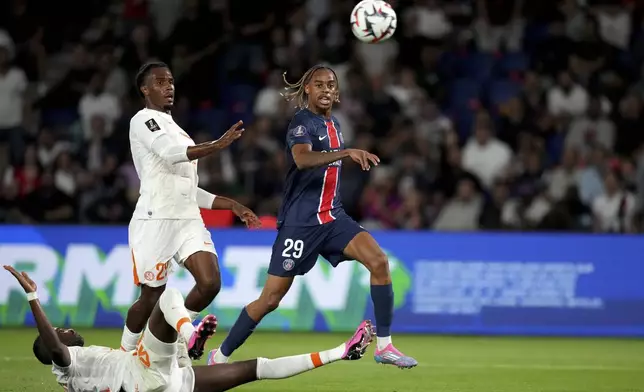 Montpellier's Enzo Tchato and PSG's Bradley Barcola, right, eye the ball during the French League 1 soccer match between Paris Saint-Germain and Montpellier at the Parc des Princes in Paris, Friday, Aug. 23, 2024. (AP Photo/Thibault Camus)