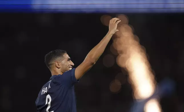 PSG's Achraf Hakimi celebrates after scoring his side's fourth goal during the French League 1 soccer match between Paris Saint-Germain and Montpellier at the Parc des Princes in Paris, Friday, Aug. 23, 2024. (AP Photo/Thibault Camus)