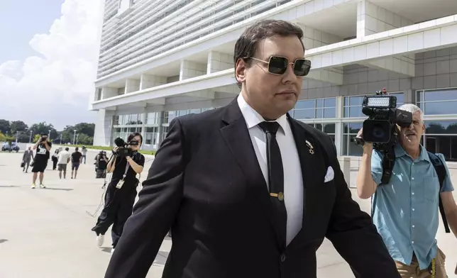 Former U.S. Rep. George Santos arrives at court in Central Islip, N.Y., Monday, Aug., 19, 2024. (AP Photo/Stefan Jeremiah)