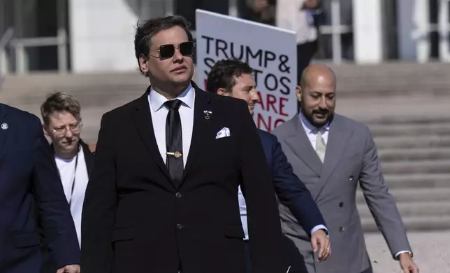 Former U.S. Rep George Santos leaves the federal courthouse with his lawyers in Central Islip, N.Y. on, Monday, Aug., 19, 2024. (AP Photo/Stefan Jeremiah)