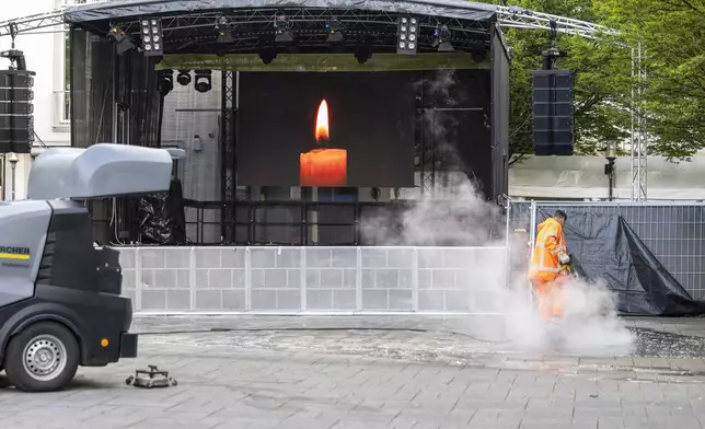 The crime scene of Friday's deadly attack at the city's 650th anniversary celebrations, is cleaned up early in the morning by cleaning staff in Solingen, Germany, Monday, Aug. 26, 2024. (Thomas Banneyer/dpa via AP)