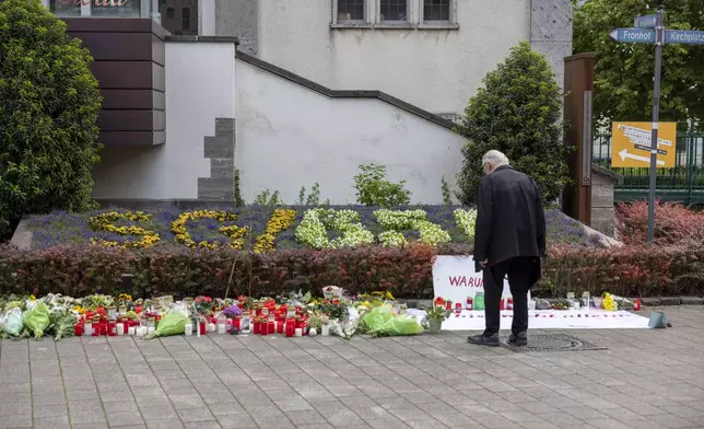 A man looks at flowers laid Sunday, Aug. 25, 2024, near the scene of Friday's deadly attack at the city's 650th anniversary celebrations in the city center of Solingen, Germany. (Thomas Banneyer/dpa via AP)