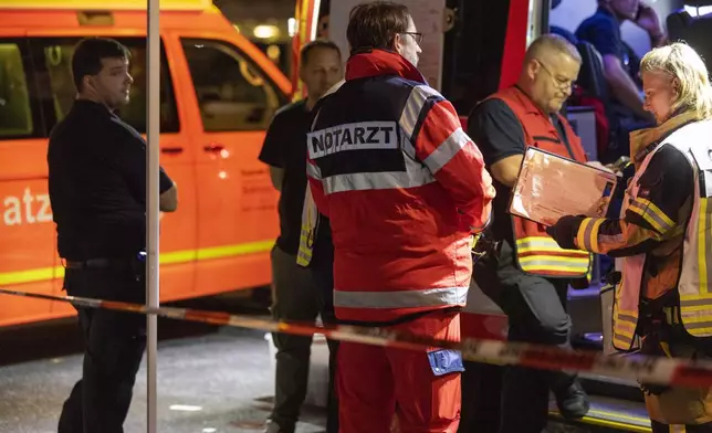 Emergency services near the scene where people were killed and injured in an attack at a festival in Solingen, western Germany, the German dpa news agency reported, Friday, Aug. 23, 2024. (Gianni Gattus/dpa via AP)