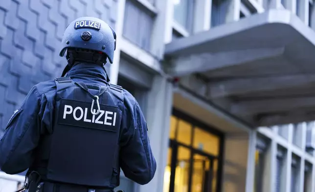 A special police task force (SEK) carries out an operation at a refugee shelter which, according to the police, is connected to the fatal knife attack Friday at the festival in Solingen, Germany, Saturday, Aug. 24, 2024. (Christoph Reichwein/dpa via AP)