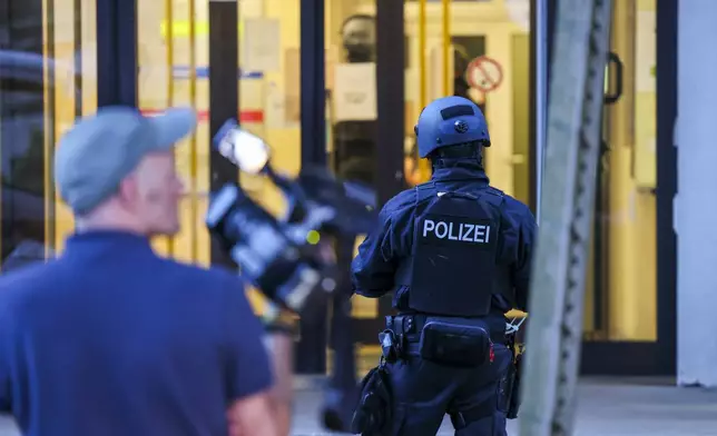 A special police task force (SEK) carries out an operation at a refugee shelter which, according to the police, is connected to the fatal knife attack on Friday at the festival in Solingen, Germany, Saturday, Aug. 24, 2024. (Christoph Reichwein/dpa via AP)