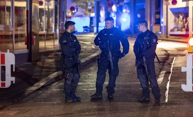 Police and deployed near the scene where people were killed and injured in an attack at a festival in Solingen, western Germany, the German dpa news agency reported, Friday, Aug. 23, 2024. (Gianni Gattus/dpa via AP)