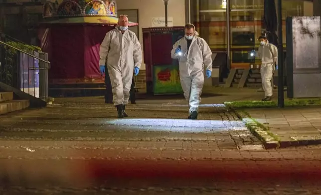 Investigators respond early Saturday, Aug. 24, 2024, after multiple people were killed and injured during an attack late Friday at the 650th anniversary celebrations of the city of Solingen, western Germany. (Thomas Banneyer/dpa via AP)