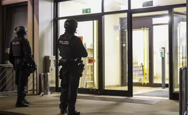 Special police forces carry out an operation at a refugee shelter in Solingen, Germany, on Saturday, Aug. 24, 2024, during an investigation into a fatal knife attack at the city's 650th anniversary celebrations. (Christoph Reichwein/dpa via AP)