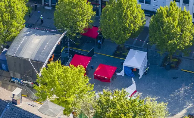 Emergency services tents stand in front of the stage in Solingen city center, Germany, Saturday Aug. 24, 2024, after three people were killed and at least eight people were wounded in a knife attack Friday night at the festival. (Christoph Reichwein/dpa via AP)