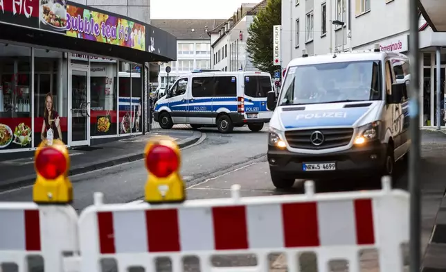 Police cars sit at a cordon early Saturday, Aug. 24, 2024, after several people were killed and injured in an attack at the Solingen's 650th anniversary celebrations late Friday. (Christoph Reichwein/dpa via AP)