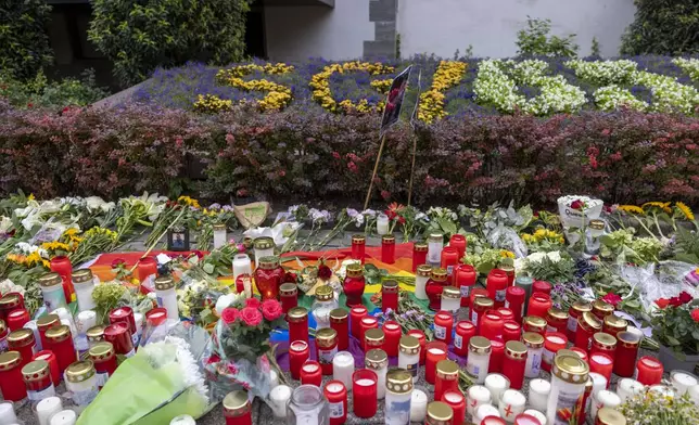 Flowers and candles are placed in Solingen, Germany, Sunday, Aug. 25, 2024, near the scene of Friday's deadly attack. (Thomas Banneyer/dpa via AP)