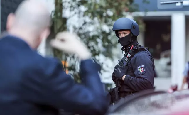 A special police task force (SEK) is carries out an operation at a refugee shelter which, according to the police, is connected to the fatal knife attack Friday at the festival in Solingen, Germany, Saturday, Aug. 24, 2024. (Christoph Reichwein/dpa via AP)