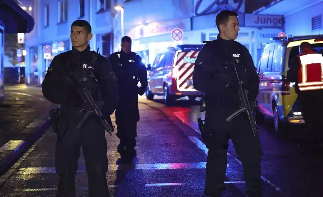 Police and ambulances near the scene where people were killed and injured in an attack at a festival in Solingen, western Germany, the German dpa news agency reported, Friday, Aug. 23, 2024. (Gianni Gattus/dpa via AP)