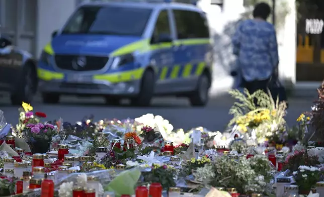 Flowers and candles are laid near the scene of a deadly knife attack during a festival, in Solingen, Germany, Wednesday, Aug. 28, 2024.(Federico Gambarini/dpa via AP)