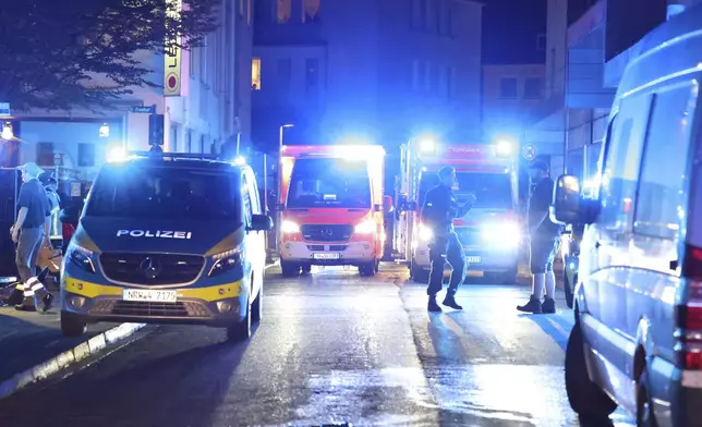 Police and ambulances near the scene where people were killed and injured in an attack at a festival in Solingen, western Germany, the German dpa news agency reported, Friday, Aug. 23, 2024. (Gianni Gattus/dpa via AP)