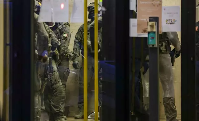 Special police forces carry out an operation at a refugee shelter in Solingen, Germany, on Saturday, Aug. 24, 2024, during an investigation into a fatal knife attack at the city's 650th anniversary celebrations. (Christoph Reichwein/dpa via AP)