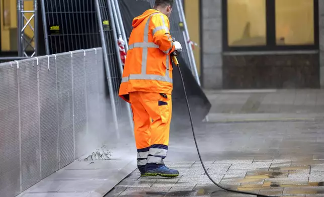 The crime scene of Friday's deadly attack at the city's 650th anniversary celebrations, is cleaned up early in the morning by cleaning staff in Solingen, Germany, Monday, Aug. 26, 2024. (Thomas Banneyer/dpa via AP)