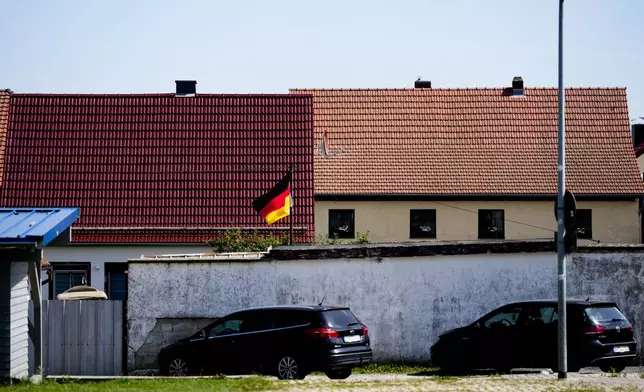 A German national flag waves in the courtyard of a building in the small village of Milda in Germany's federal state Thuringia, Wednesday, Aug. 14, 2024. In the federal state Thuringia, in former East Germany, the citizens are called to vote for a new state parliament on Sept. 1, 2024. (AP Photo/Markus Schreiber)