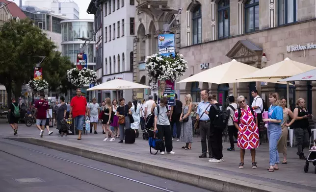 Electoral posters of the far-right Alternative for Germany, or And, using the slogan "Summer, Sun, Remigration," and depicting a plane dubbed "Deportation Airline" is displayed at a public transport station in the capital of German federal state Thuringia, in Erfurt, Germany, Wednesday, Aug. 14, 2024. In the federal state Thuringia, in former East Germany, the citizens are called to vote for a new state parliament on Sept. 1, 2024. (AP Photo/Markus Schreiber)