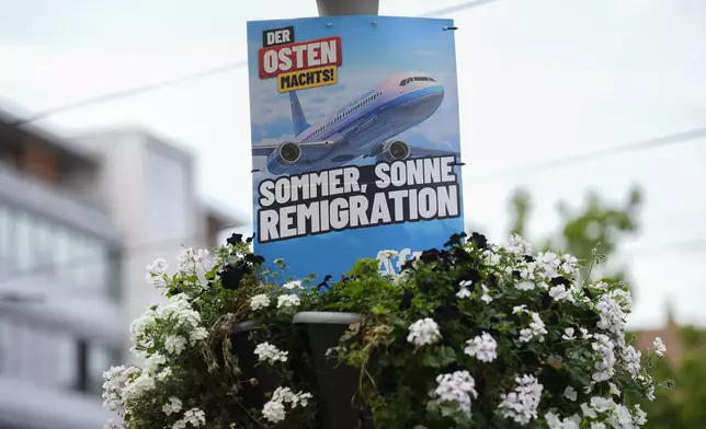 An electoral poster for the far-right Alternative for Germany, or And, using the slogan, "Summer, Sun, Remigration," and depicting a plane dubbed "Deportation Airline", is displayed in the capital of German federal state Thuringia, in Erfurt, Germany, Wednesday, Aug. 14, 2024. In the federal state Thuringia, in former East Germany, the citizens are called to vote for a new state parliament on Sept. 1, 2024. (AP Photo/Markus Schreiber)