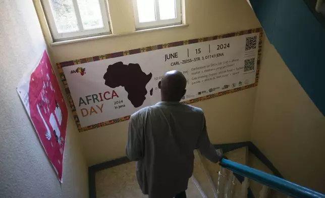 Daniel Egbe, a chemist from Cameroon who moved to Thuringia in 1994 to study, walks down the staircase Tuesday, Aug. 13, 2024, at the AMAH, an organization that is based in the city of Jena and helps university students and migrants from Africa when they experience discrimination in Jena, Germany. (AP Photo/Markus Schreiber)