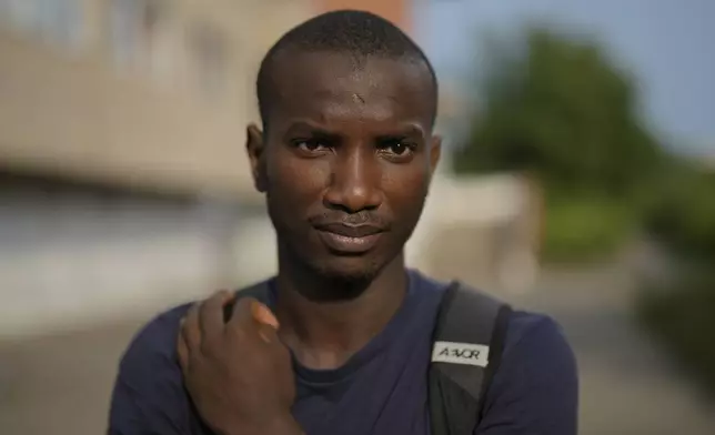 Omar Diallo, a 22-year-old migrant from Guinea in West Africa, poses for a portrait prior to an interview with The Associated Press near a dilapidated storage building where he and two friends were hunted and beaten up in 2020, in Erfurt, Germany, Wednesday, Aug. 14, 2024. (AP Photo/Markus Schreiber)