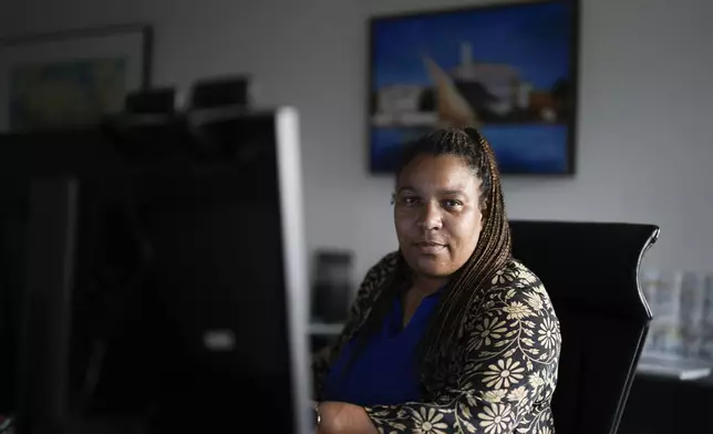 Doreen Denstaedt, German federal state Thuringia's minister for migration, justice and consumer protection, poses for a portrait at her desk prior to an interview with The Associated Press in Erfurt, Germany, Wednesday, Aug. 14, 2024. Denstaedt, the daughter of a Black father from Tanzania and a white, German mother, was born and grew up in Thuringiain and is a member of the Green Party. (AP Photo/Markus Schreiber)