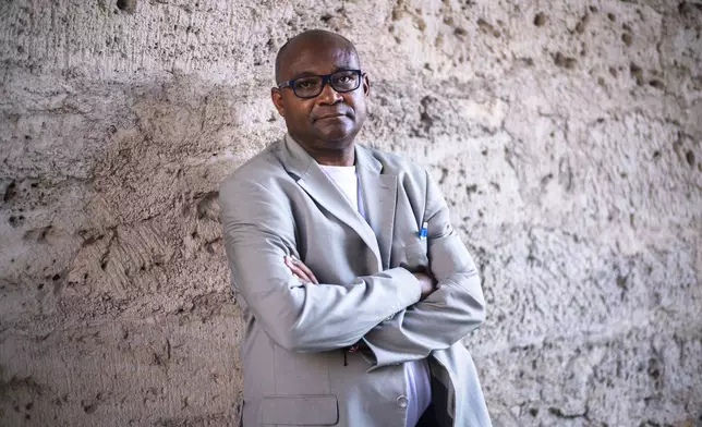 Daniel Egbe, a chemist from Cameroon who moved to Thuringia in 1994 to study, poses for a portrait after an interview with The Associated Press in Jena, Germany, Tuesday, Aug. 13, 2024. (AP Photo/Markus Schreiber)